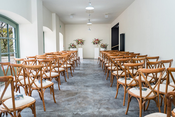 Kinclune Steading ceremony room with flowers and wooden chairs